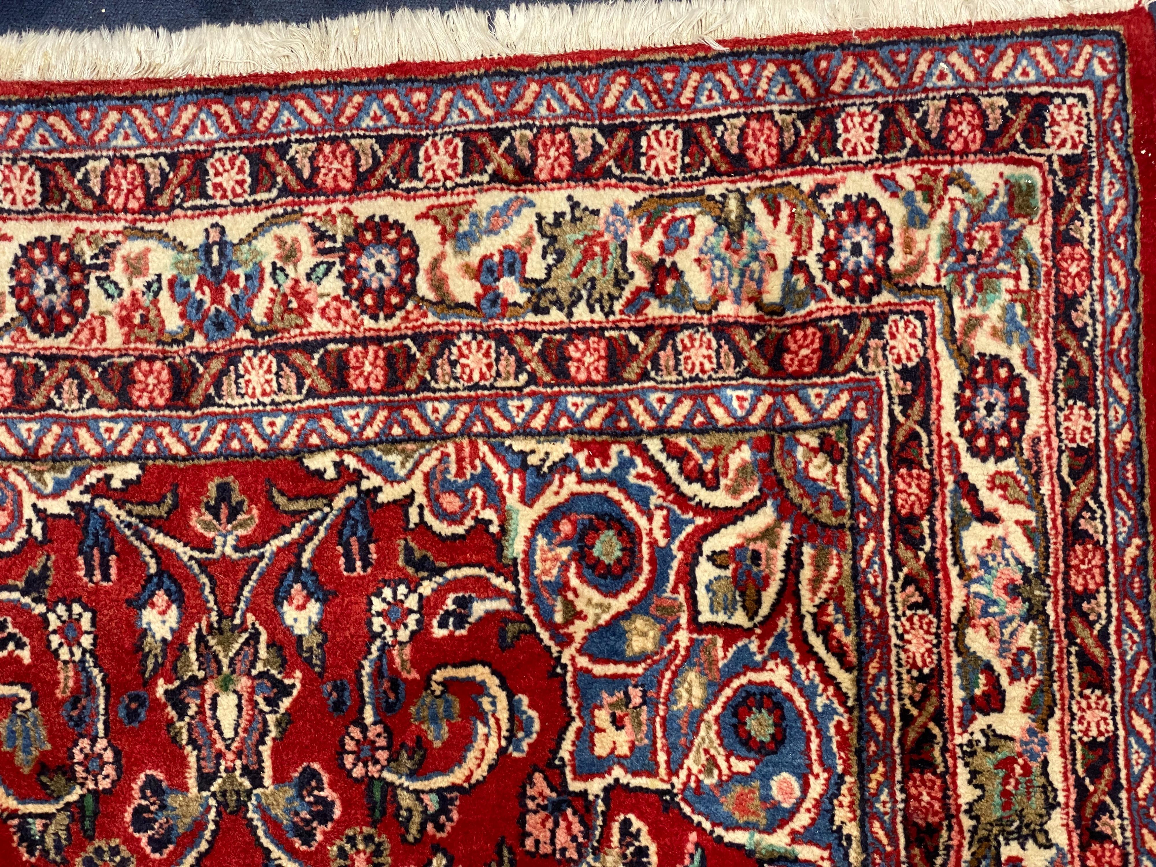 A Northwest Persian red ground rug, 240 cm x 136 cm